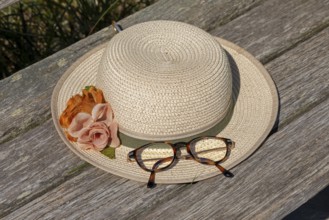 Straw hat and glasses lying on a bench, circular hiking trail, Darßer Ort, Born a. Darß,