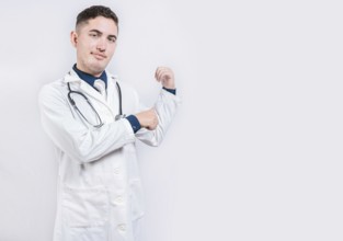 Doctor pointing back with his thumbs, recommending a product. Smiling latin doctor pointing back