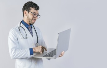 Handsome doctor using laptop isolated. Young doctor in glasses using notebook on isolated