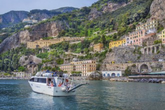 Waterfront of the village with excursion boat, Amalfi, Amalfi Coast, Amalfitana, Campania, Italy,