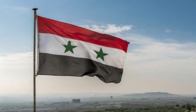 The flag of Syria flutters in the wind