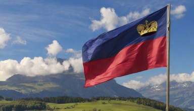 The flag of Liechtenstein flutters in the wind