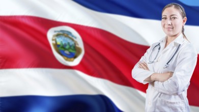 Smiling doctor with crossed arms with Costa Rican flag in the background. Health care concept with