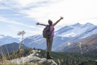 Woman Hiking and with Her Arms Outstretched and Enjoy Mountain Scape with Snow in San Bernardino,