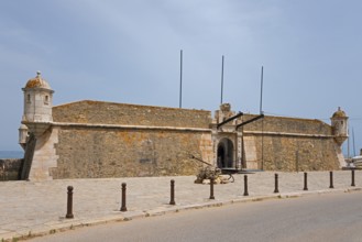 Old stone fortress by the road under a blue sky, Forte da Ponta da Bandeira, Fortress, Lagos,