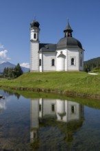 Seekirchl with reflection, Heiligkreuzkirche, Seefeld, Tyrol, Austria, Europe