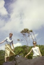 Two expatriate British women teachers standing on rock at the coast, Balandra, Trinidad, 1963