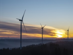 Three wind turbines at sunrise over fog-covered forests, Rems Valley, Baden-Württemberg, Germany,