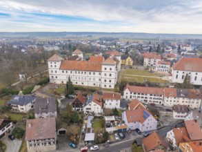 Historic castle surrounded by small houses and rural landscape under a cloudy sky, Meßkirch,