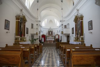 Bright church interior with wooden benches and magnificent altar, Benedictine monastery and Church