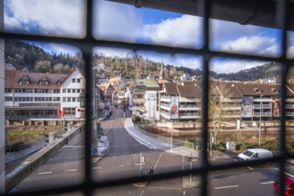 View through a grid of a town with buildings, streets and a church tower, car park ZOB of