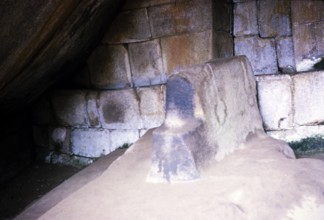 Caption: Sacrificial stone in a round temple, probably in the royal burial site of the Temple of