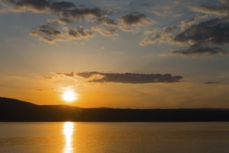 Orange-coloured sky at sunset over a calm sea, Glavotok, island of Krk, Primorje-Gorski kotar,