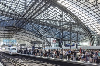 Central station with glass roof construction, crowds of people on the platform, Deutsche Bahn ICE,