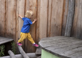 Little girl, 3 years, blonde, balancing, gymnastics, playing, adventure playground, playground,