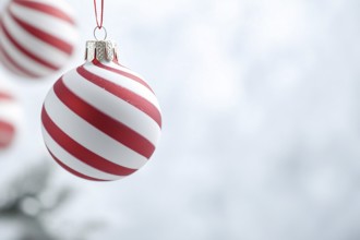 Christmas bauble ornament with red and white stripes on tree with copy space. Generative AI, AI