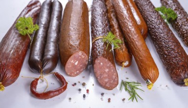 Food, meat products, various smoked sausages on a white surface AI generated, AI generated