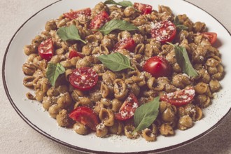 Tuscan pasta with smoked paprika and basil, parmesan cheese, Italian traditional cuisine