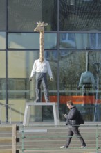 Modern building of the broadcasting station Arte of ARD and ZDF with sculpture giraffe man by