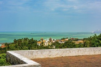 Historic city of Olinda in Pernambuco seen from the courtyard of the old church with the sea in the