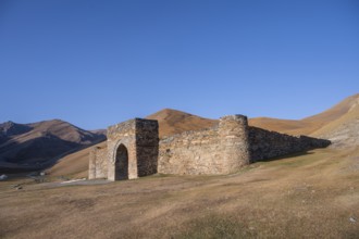 Historic caravanserai Tash Rabat from the 15th century, with yellow hills, Atbashy district in the