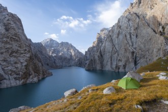 Wild camping, camping in the wilderness with a tent in front of mountain lake Kol Suu, Sary Beles