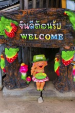 Welcome, sign in a hotel entrance, greeting, inviting, colourful, shrill, asian, friendly, hint,