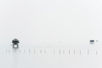 Traditional wooden huts of fishermen in the Gulf of Thailand in the morning haze, fisherman,