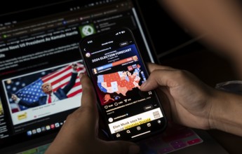 In this photo illustration, a person watch results of U.S. elections on a smartphone in Guwahati,