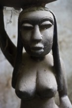 Old wooden statuette representing an african woman. Gambia