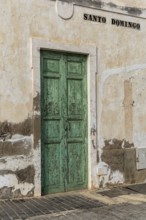 Weathered green door in an old building wall with the lettering 'Santo Domingo', Canary Islands,