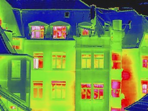 Apartment block, facade of a residential building with windows. Thermal image or thermography,