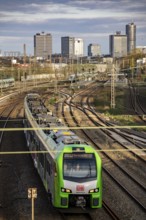 Train on the tracks west of Essen main station, skyline of the city centre, S-Bahn train, North