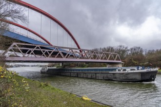 Freighter, dilapidated motorway bridge A42, (red arches) over the Rhine-Herne Canal, with massive