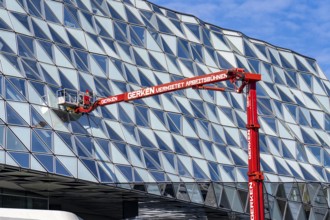 Building cleaners cleaning window panes, cleaning a facade, lorry working platform of the German