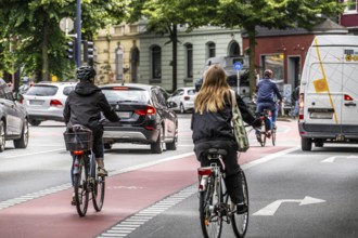 Bicycle lane, marked red, between 2 lanes for vehicles, city centre traffic, Dortmund, North