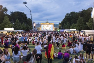 Fassball fans celebrate and gather information in the fan zone at the Brandenburg Tor after the