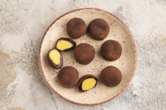 Japanese rice sweet buns chocolate mochi filled with cream on brown concrete background. top view,