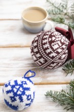 Christmas or New Year composition. Decorations, knitted balls, fir and spruce branches, cup of