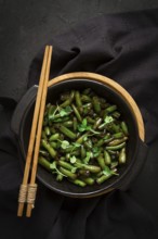 Fried bean pods, in soy sauce, with sesame seeds, homemade, no people