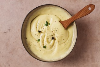 Mashed potatoes, with micro greenery and spices, homemade, on a beige table, no people, top view