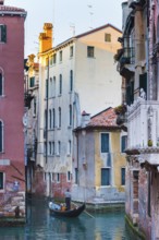 Gondola with tourists in the side canal of the old town, old building, city trip, holiday, travel,