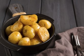 Fresh Cooked, new potatoes, with dill, on a wooden table, selective focus. close-up, toning, no