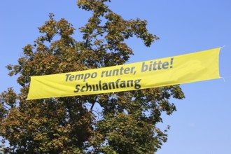 Tension tape over the road with a sign for school starters