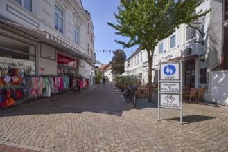 Traffic sign pedestrian zone and fashion shop in the city centre of Varel, district of Friesland,