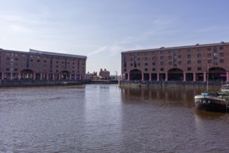 View of the harbour with brick buildings and boats, Liverpool