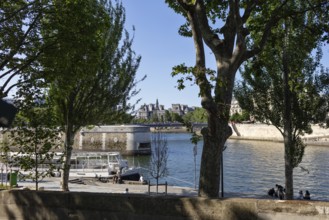 View over the riverbank with boats and historic buildings, Paris