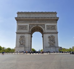 A central view of the Arc de Triomphe on a clear day with few people, Paris