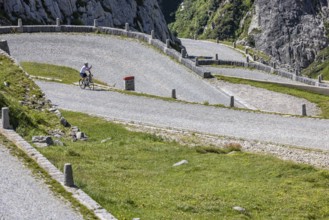 Cyclists on the road on La Tremola, the world-famous Alpine pass through the Val Tremolo,