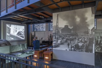 Visitors watching the August 8, 1956 Le Bois du Cazier coal mining disaster in the coal mine museum